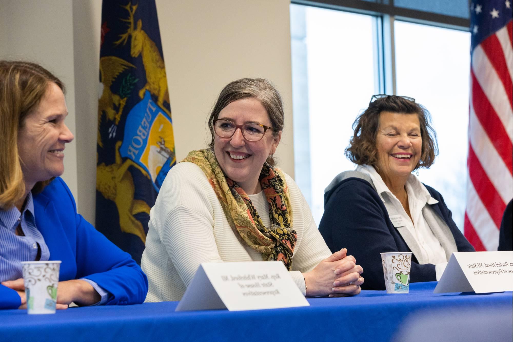 Three women smiling and talking